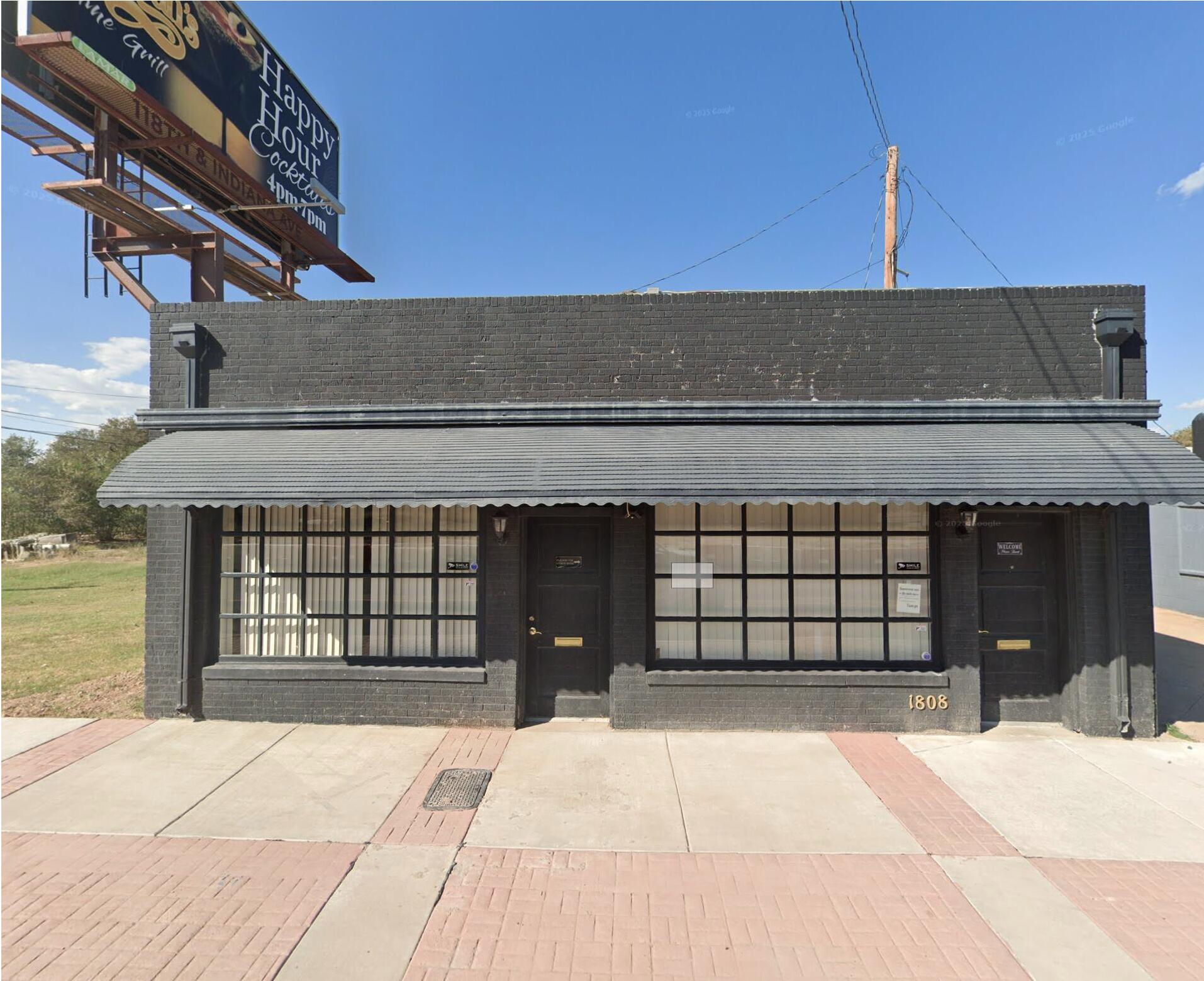 1812 Avenue R Lubbock, TX 79401 - Photo 2 of 5 a view of a brick house with a garage