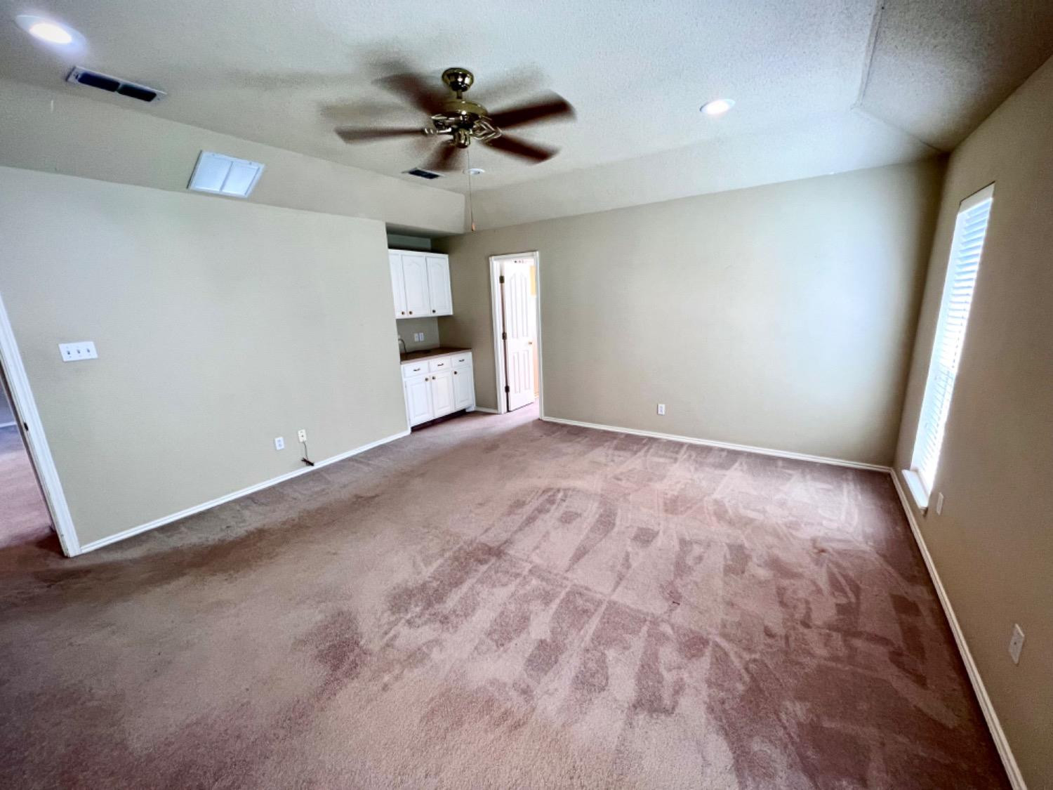 405 Sooner Street Wolfforth, TX 79382 - Photo 13 of 24 a view of an empty room with a window