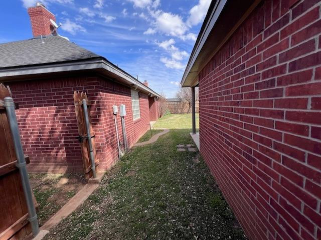 405 Sooner Street Wolfforth, TX 79382 - Photo 20 of 24 a view of a brick house with a yard