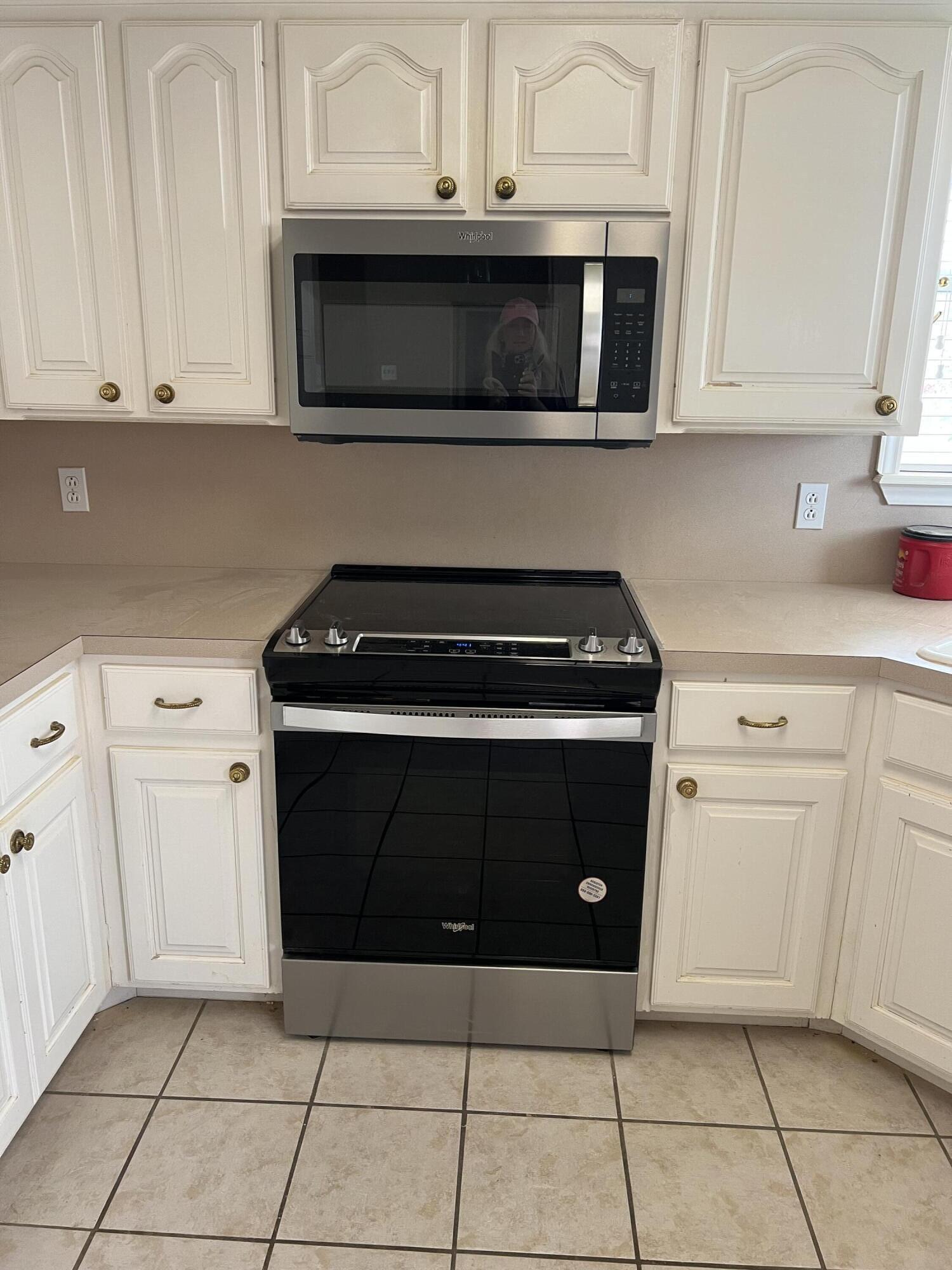 405 Sooner Street Wolfforth, TX 79382 - Photo 7 of 24 a kitchen with granite countertop white cabinets and stainless steel appliances