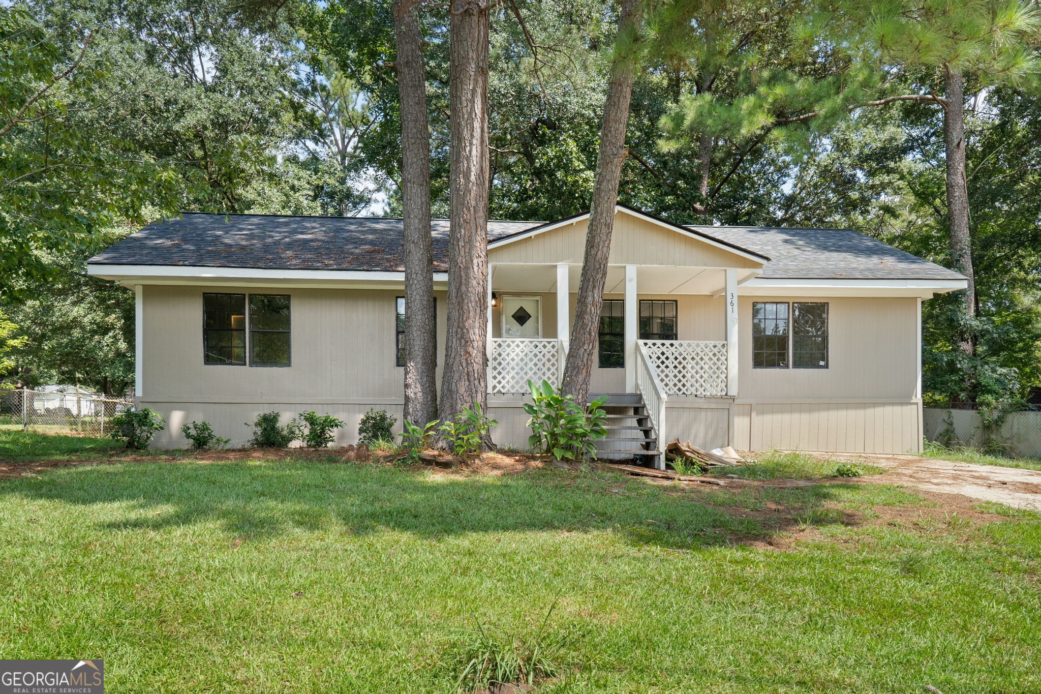 361 Hemlock Lane Locust Grove, GA 30248 - Photo 1 of 20 a front view of a house with a yard and trees