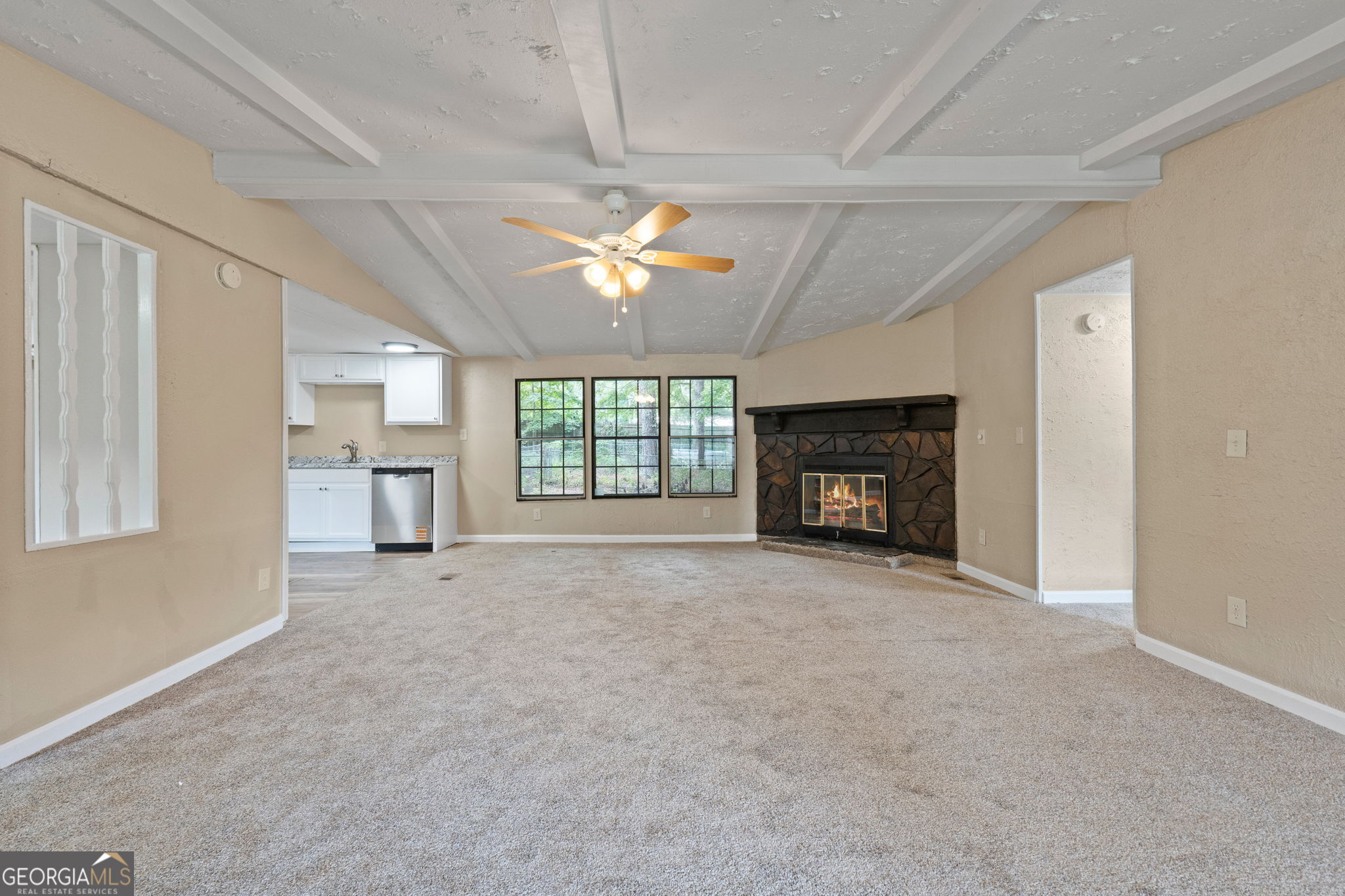 361 Hemlock Lane Locust Grove, GA 30248 - Photo 4 of 20 a view of an empty room with a fireplace and a window