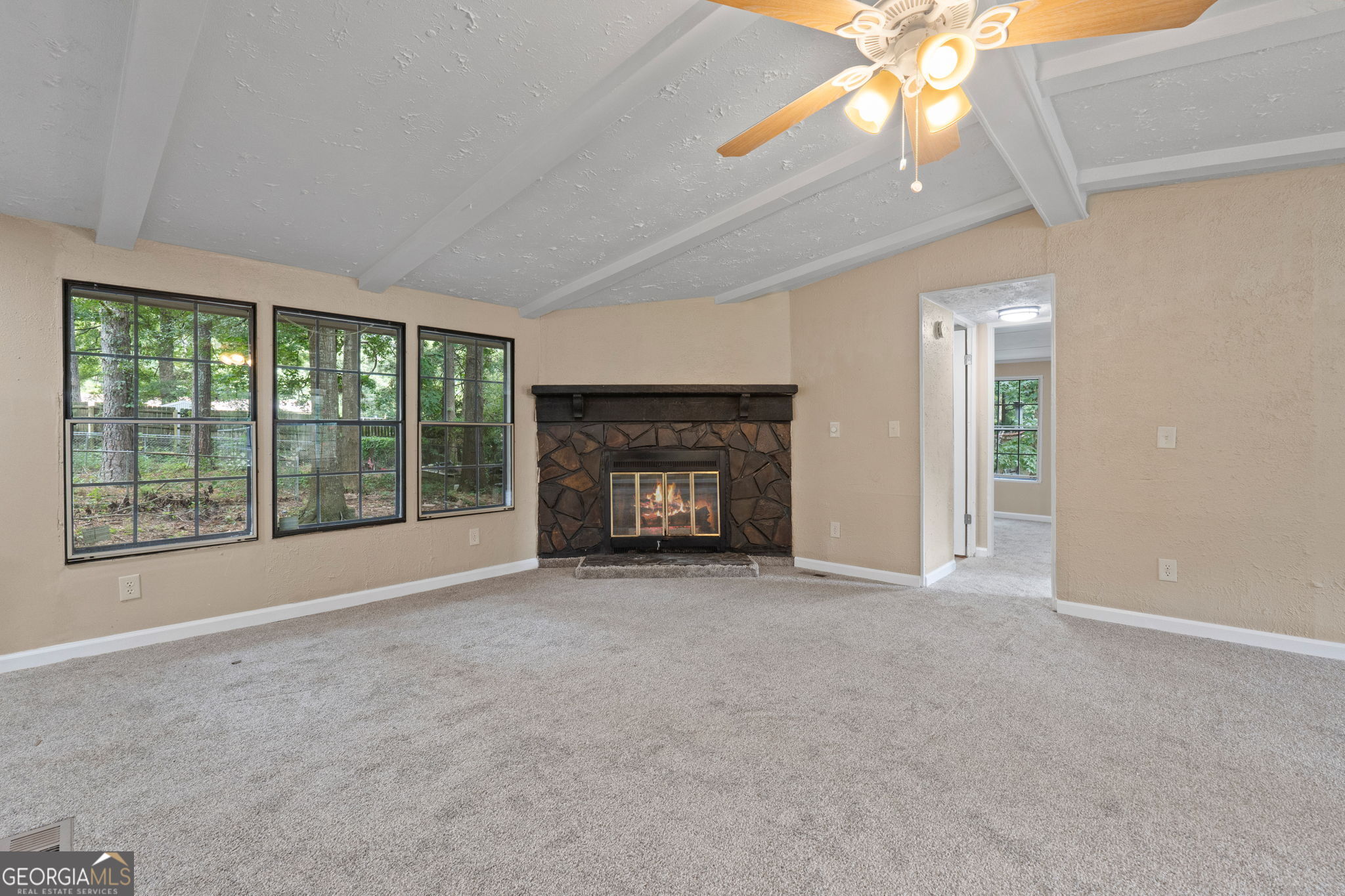 361 Hemlock Lane Locust Grove, GA 30248 - Photo 5 of 20 a view of an empty room with a window and a fireplace