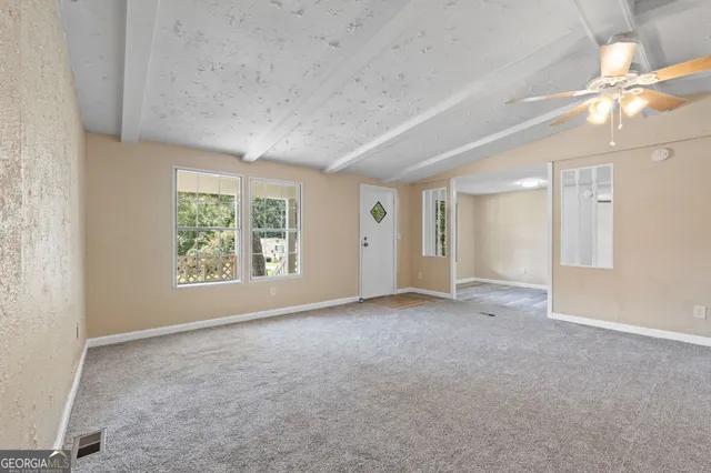 an empty room with windows and closet