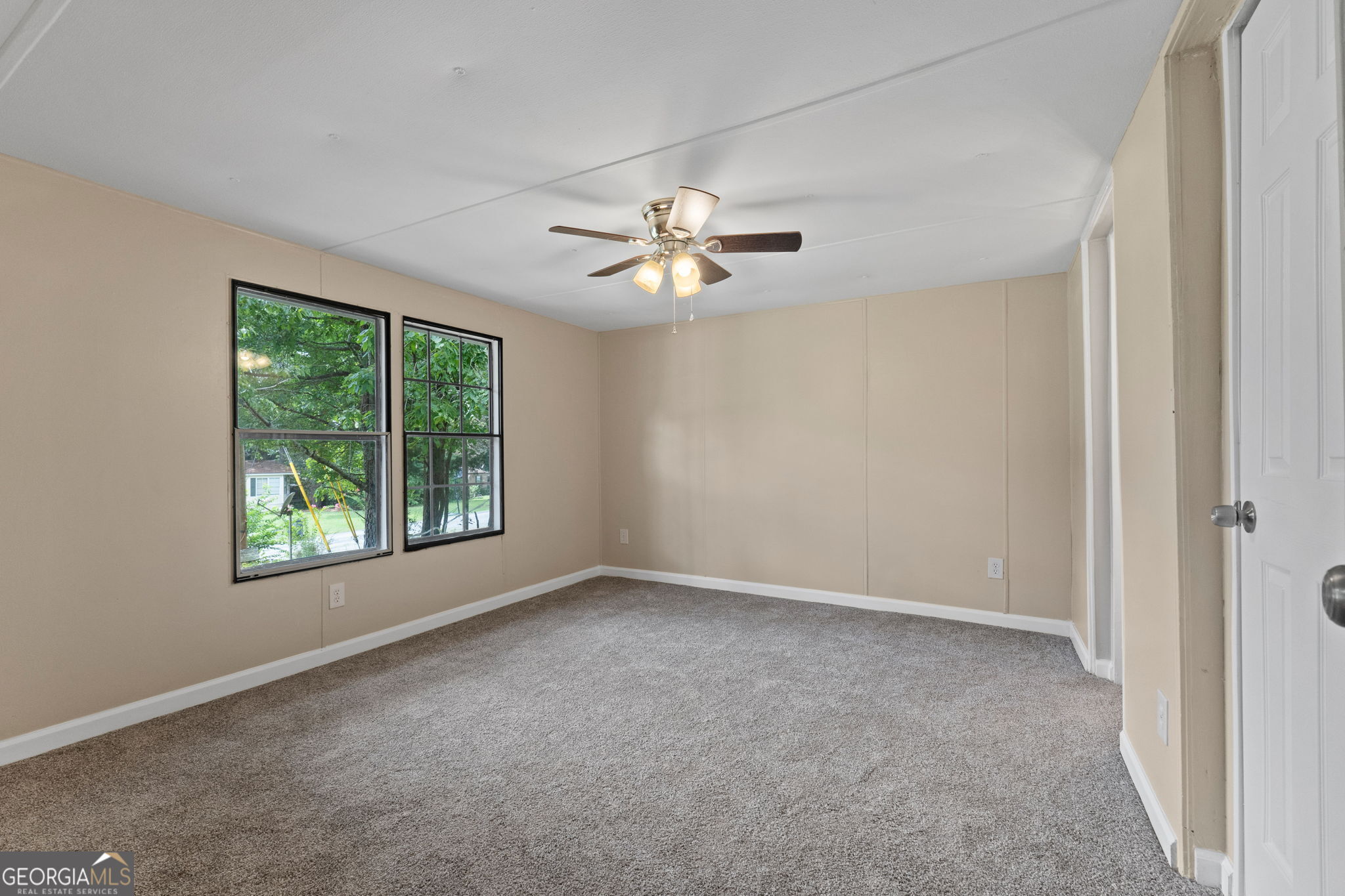 361 Hemlock Lane Locust Grove, GA 30248 - Photo 10 of 20 an empty room with windows and chandelier fan