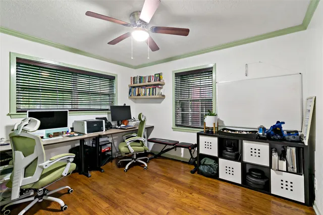 a view of a workspace with furniture and a window