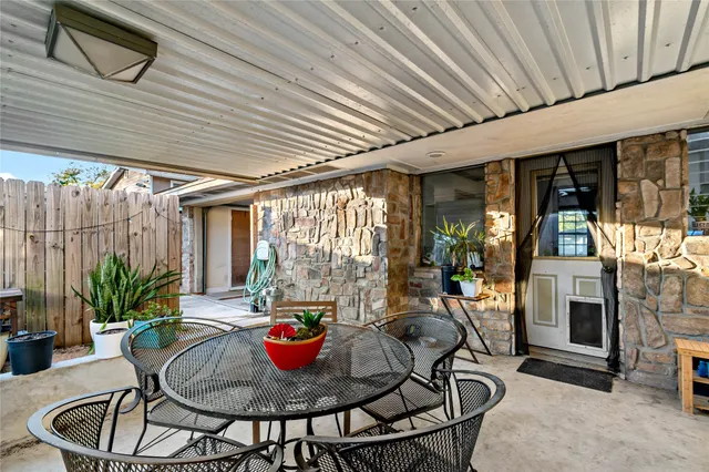 a outdoor dining space with furniture and garden view
