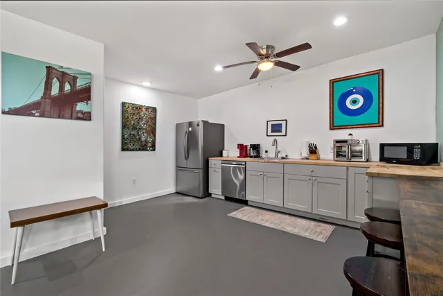 a kitchen with stainless steel appliances cabinets and a refrigerator