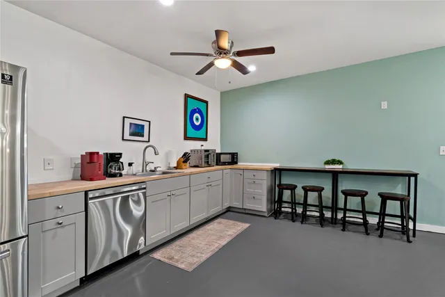 a kitchen with a white cabinets and chairs