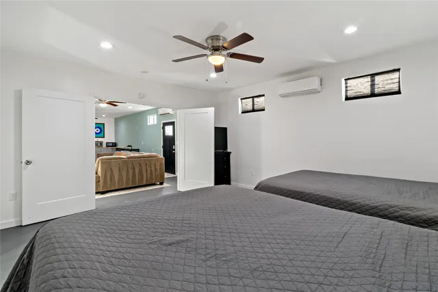 a bedroom with a large bed and a chandelier