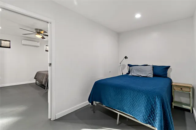 a bedroom with a bed and a tv