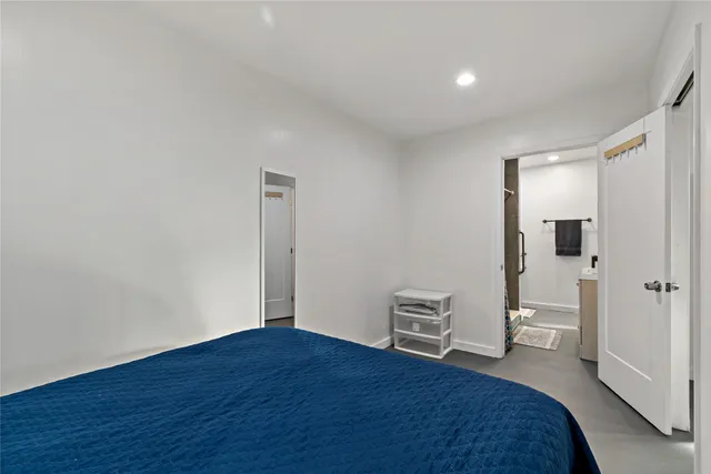 a bedroom with a bed and a toilet