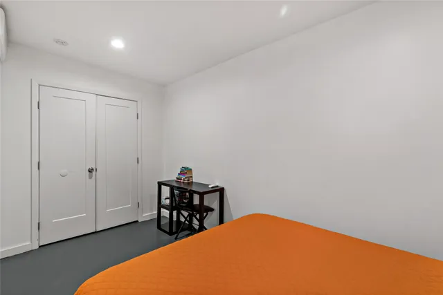 a bedroom with a bed and chair