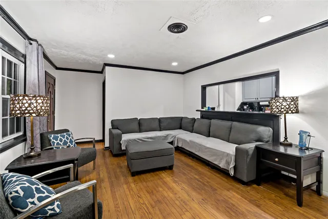 a living room with furniture and wooden floor