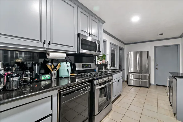 a kitchen with stainless steel appliances a stove and a refrigerator