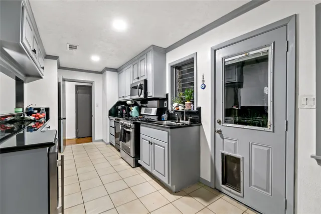 a kitchen with sink cabinets and refrigerator