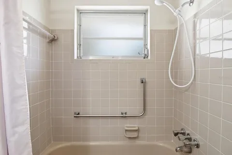 a bathroom with a bath tub and a shower