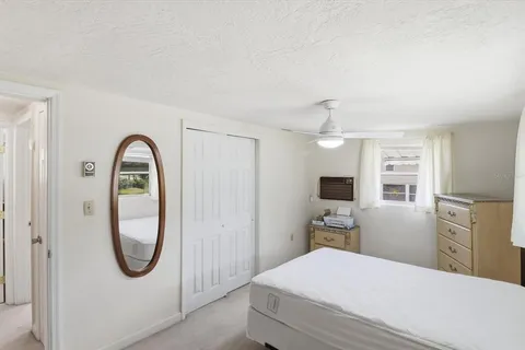 a bedroom with a bed and a mirror