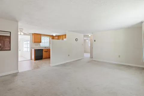 an empty room with a kitchen and a sink