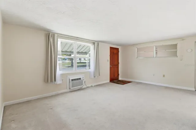 an empty room with windows and closet