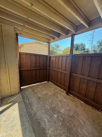 a view of backyard with wooden fence