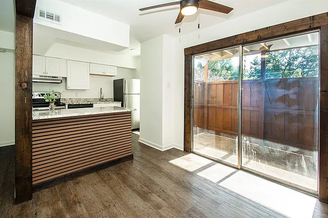 a kitchen with a window a sink and cabinets
