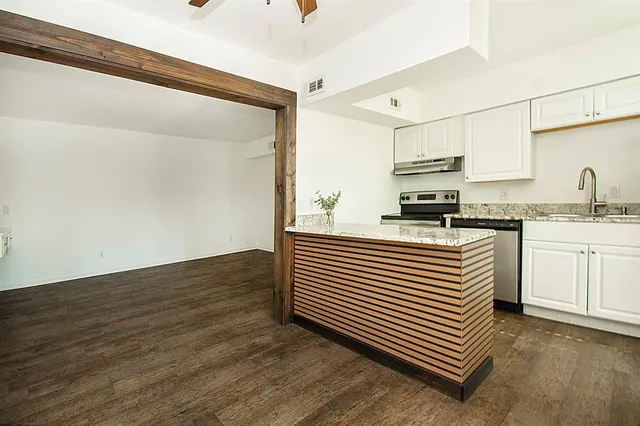 a kitchen with a sink and cabinets