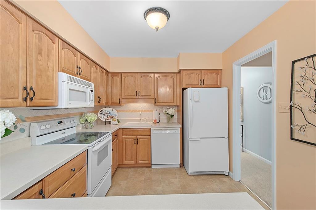 1500 Cochran Road, Unit 510 Pittsburgh, PA 15243 - Photo 11 of 25 a kitchen with a sink a refrigerator and a stove