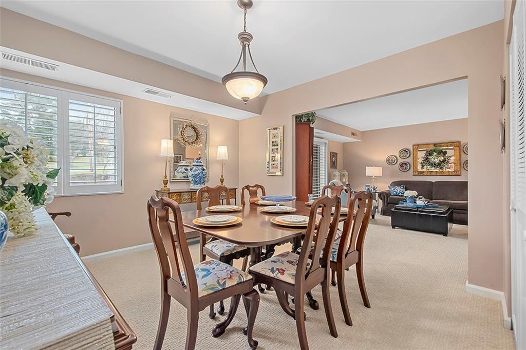 1500 Cochran Road, Unit 510 Pittsburgh, PA 15243 - Photo 14 of 25 a view of a dining room with furniture window and wooden floor