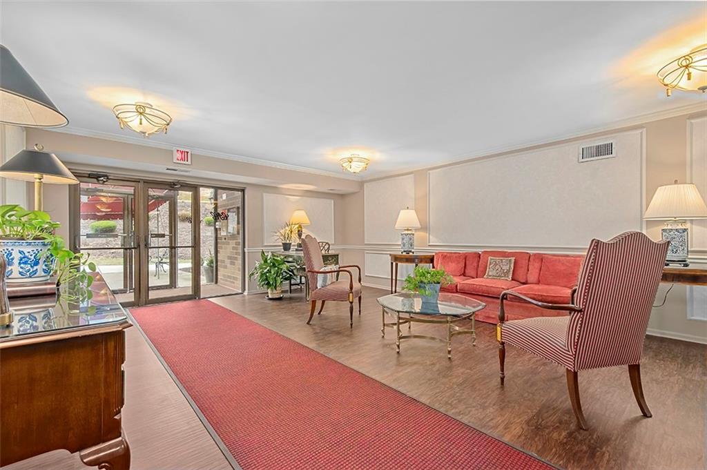 1500 Cochran Road, Unit 510 Pittsburgh, PA 15243 - Photo 3 of 25 a living room with furniture a flat screen tv and a large window