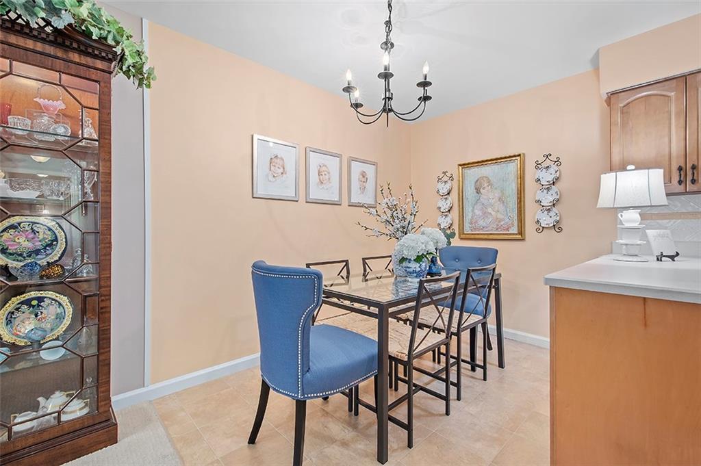 1500 Cochran Road, Unit 510 Pittsburgh, PA 15243 - Photo 9 of 25 a view of a dining room with furniture and chandelier