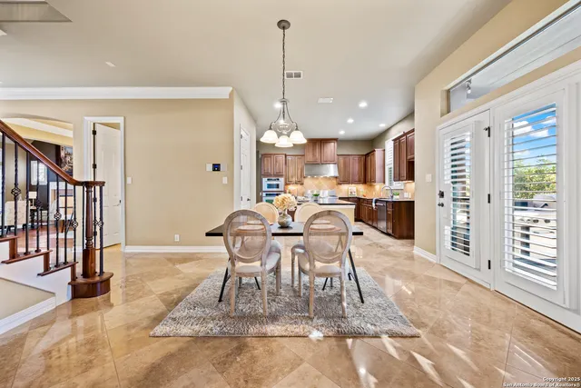 a kitchen with stainless steel appliances granite countertop a sink a stove and a refrigerator