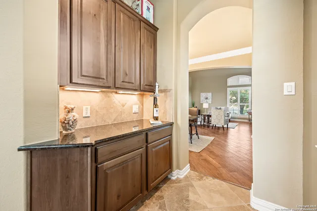 a bathroom with a granite countertop sink mirror and a shower