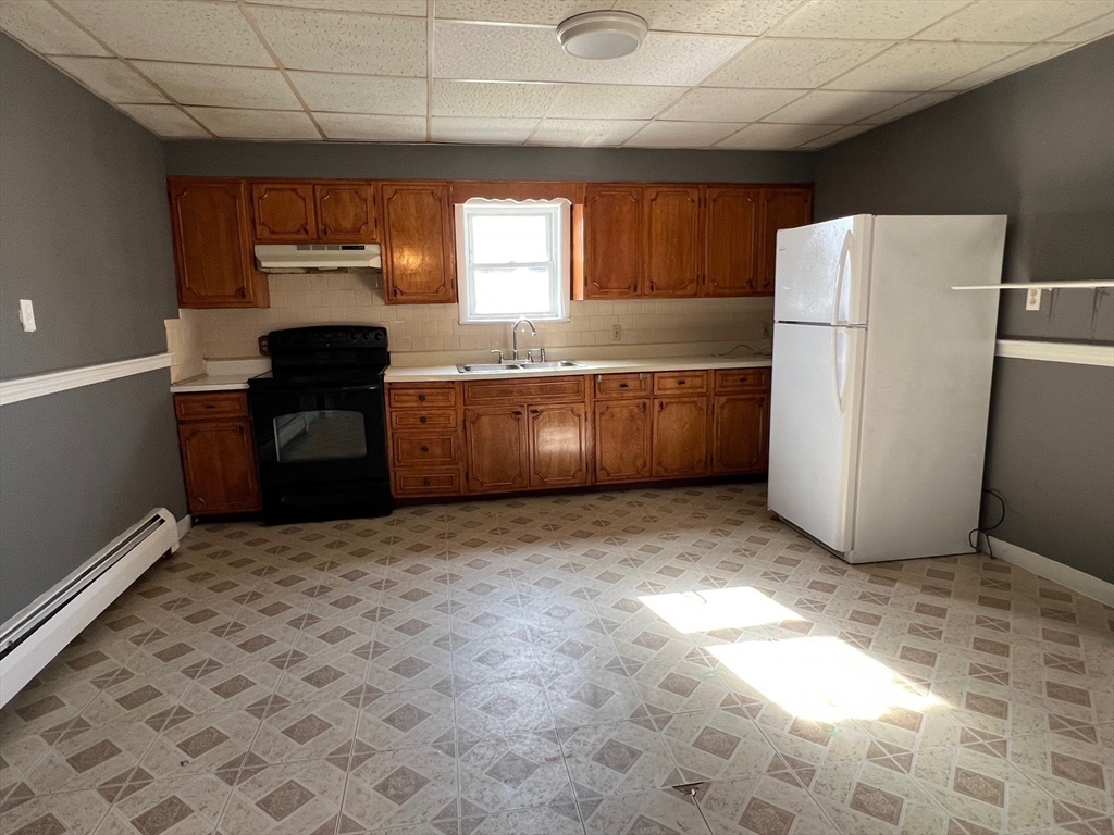 47 Acton Street Worcester, MA 01604 - Photo 14 of 30 a kitchen with refrigerator and window
