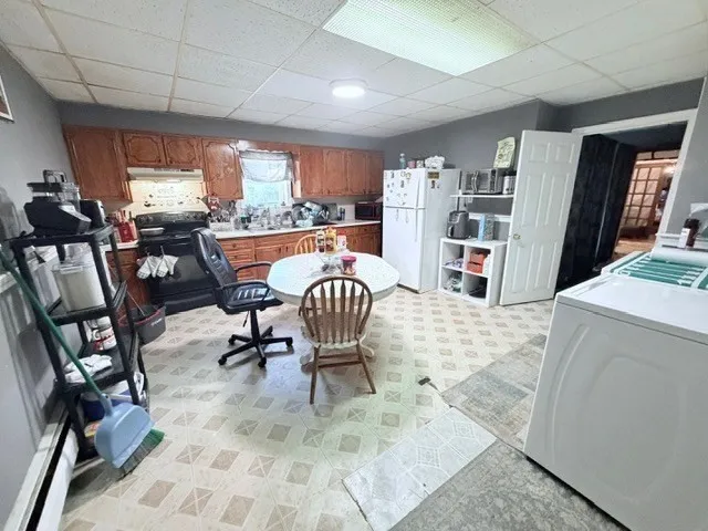 a workspace with furniture and a large window