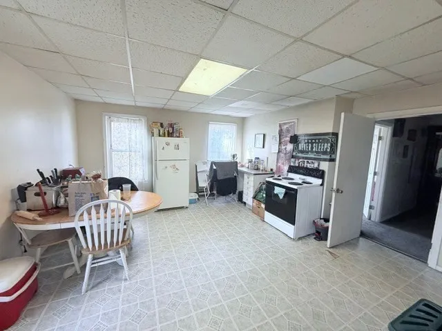 a living room with furniture and a dining table