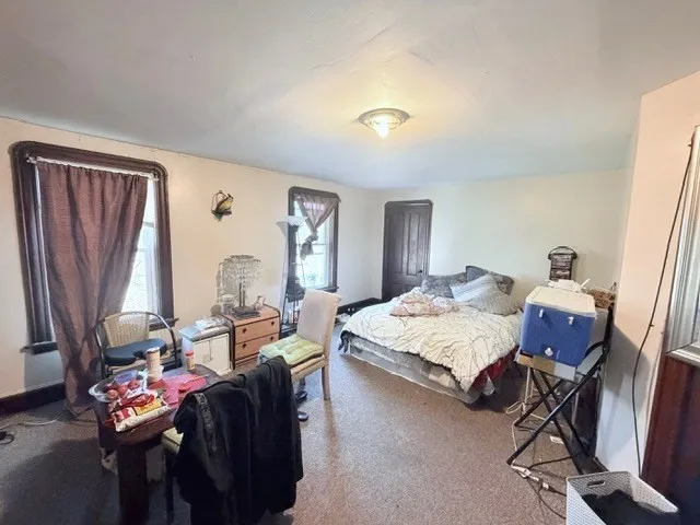 a living room with furniture a fireplace and a window