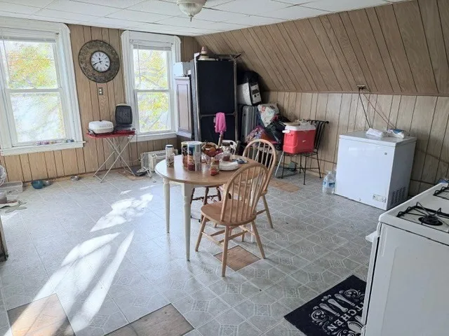 a dining room with furniture and window
