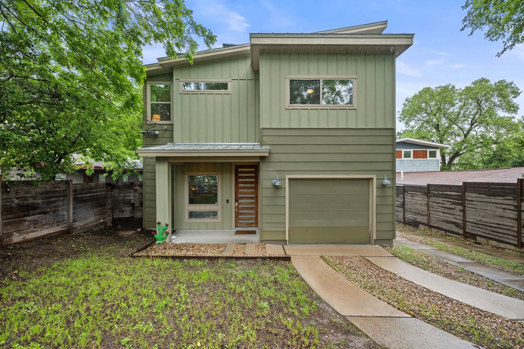 a view of a house with a yard and garage