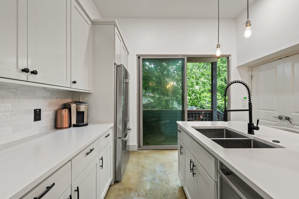 1131 Poquito Street, Unit A Austin, TX 78702 - Photo 12 of 34 a kitchen with a sink and a refrigerator