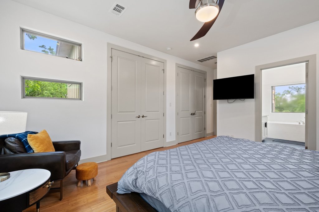 1131 Poquito Street, Unit A Austin, TX 78702 - Photo 13 of 34 a bedroom with a bed and a couch