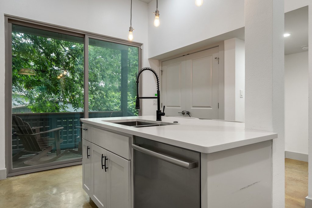 1131 Poquito Street, Unit A Austin, TX 78702 - Photo 14 of 34 a kitchen with a sink and a large window