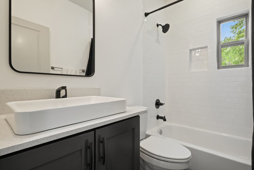1131 Poquito Street, Unit A Austin, TX 78702 - Photo 26 of 34 a white bath tub sitting next to a white sink