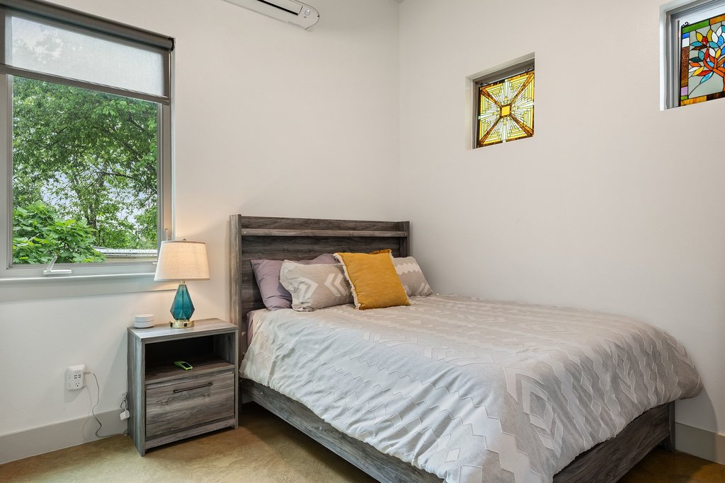 1131 Poquito Street, Unit A Austin, TX 78702 - Photo 27 of 34 a bedroom with a bed and a window