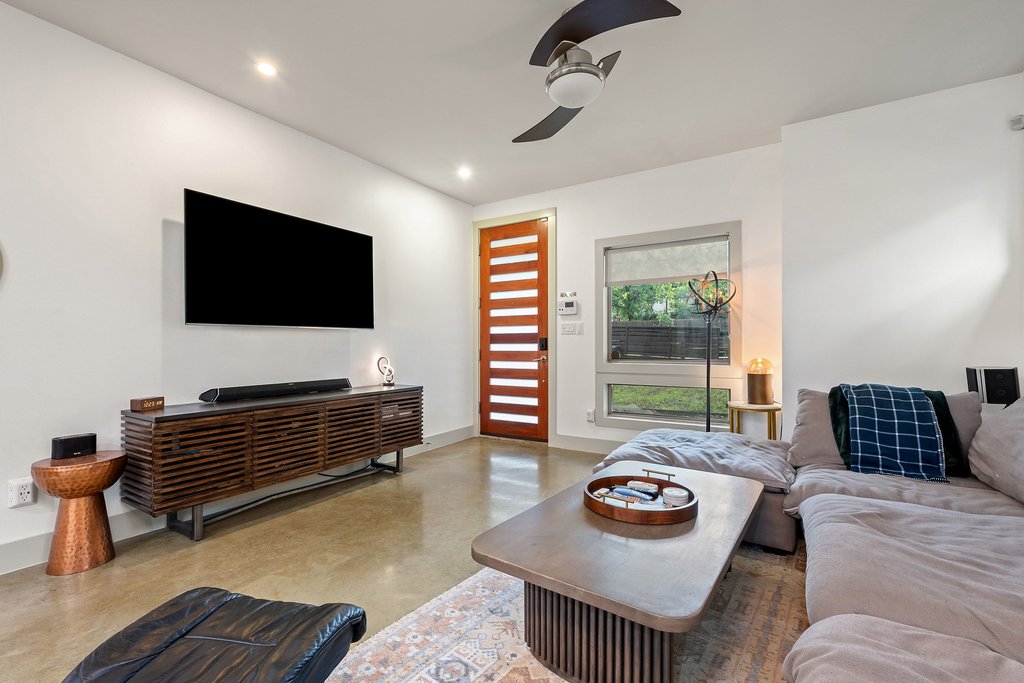 1131 Poquito Street, Unit A Austin, TX 78702 - Photo 9 of 34 a living room with furniture and a flat screen tv