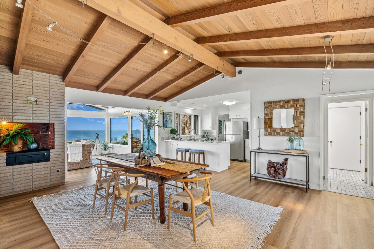 701 Seacliff Drive Aptos, CA 95003 - Photo 16 of 76 a dining room with furniture a fireplace and wooden floor