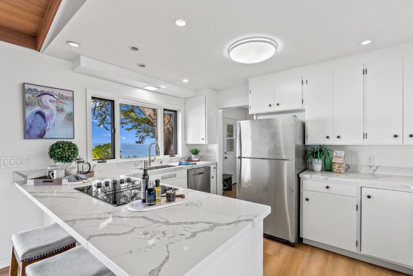 701 Seacliff Drive Aptos, CA 95003 - Photo 22 of 76 a kitchen with a refrigerator a stove a sink dishwasher and white cabinets with wooden floor