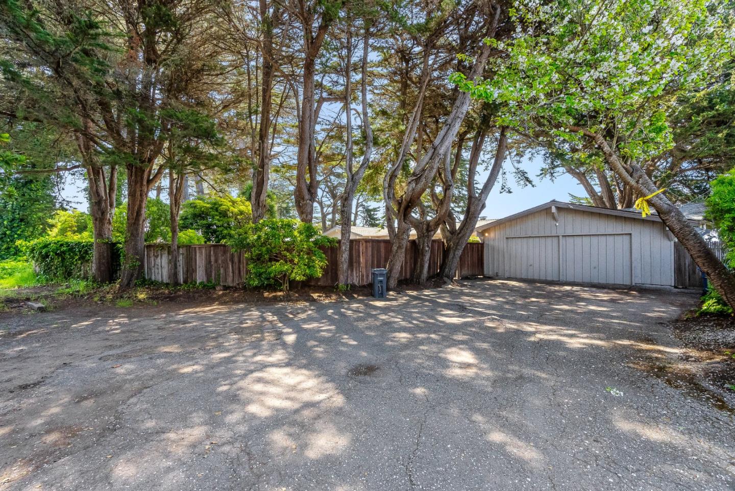 701 Seacliff Drive Aptos, CA 95003 - Photo 60 of 76 a view of a backyard with large trees and wooden fence