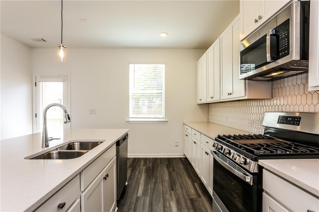 339 Sammon Way Lawrenceville, GA 30046 - Photo 8 of 20 a kitchen that has a sink and a stove top oven