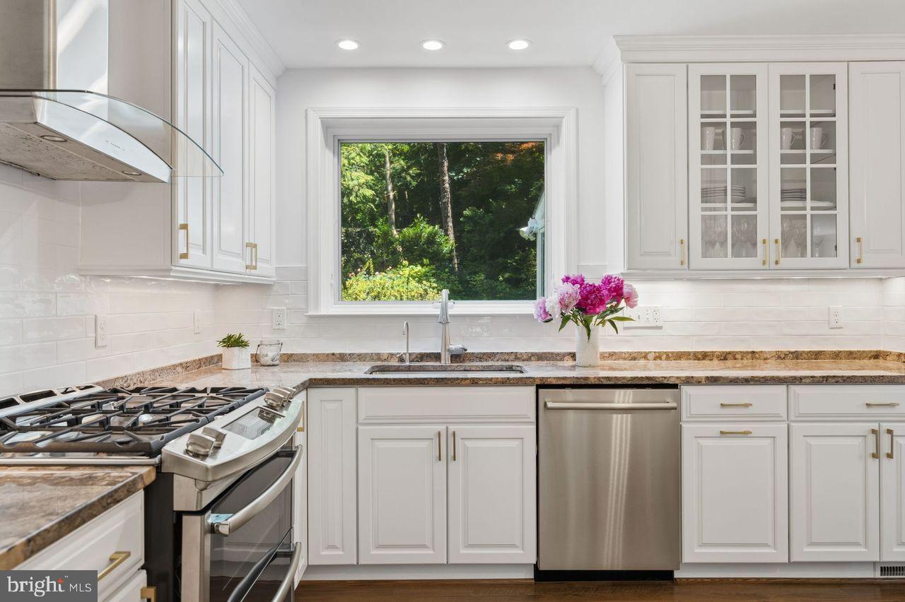 4555 W Street Northwest Washington, DC 20007 - Photo 4 of 34 a kitchen with granite countertop cabinets stainless steel appliances and sink
